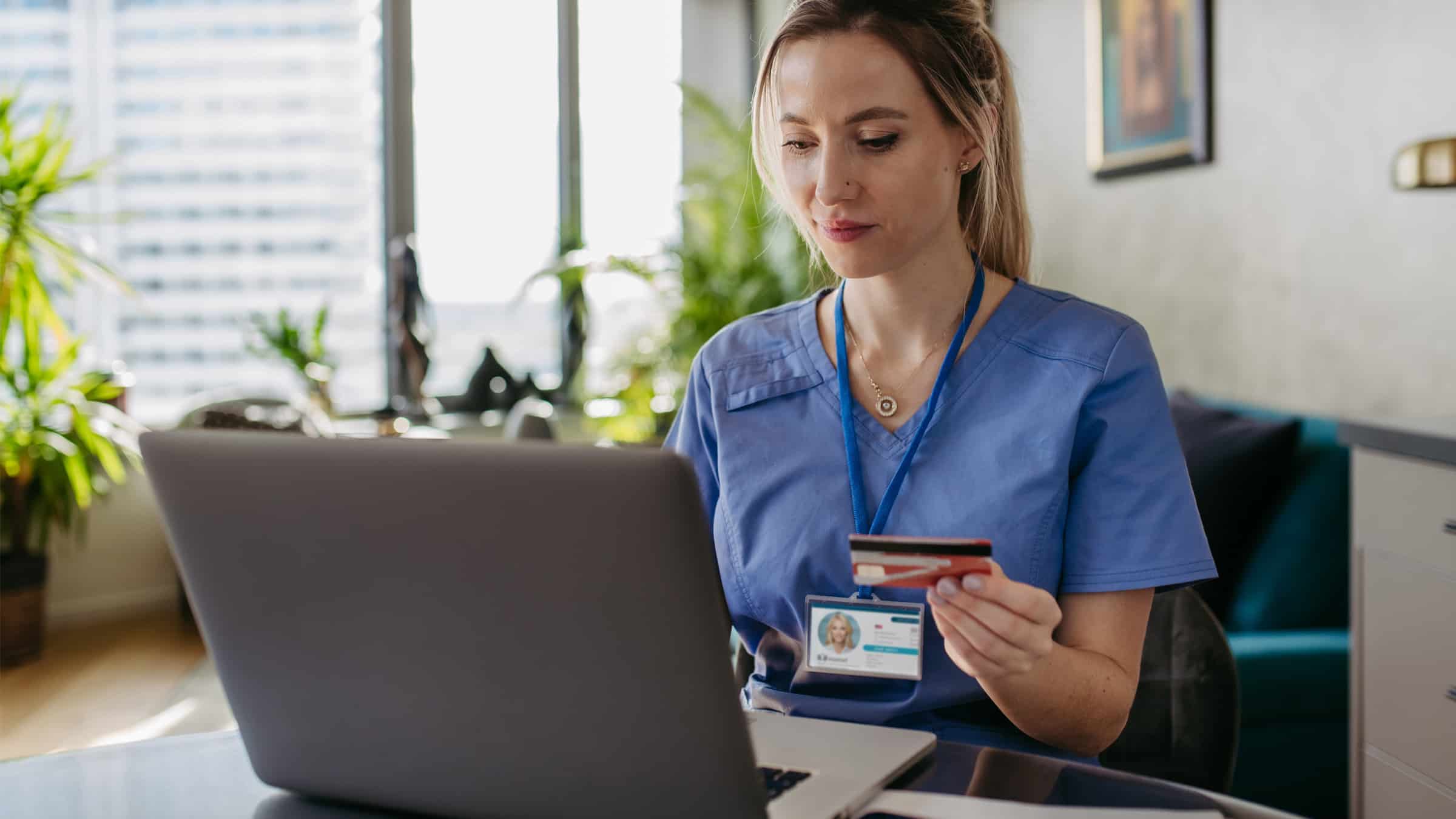 Young nurse paying her credit card