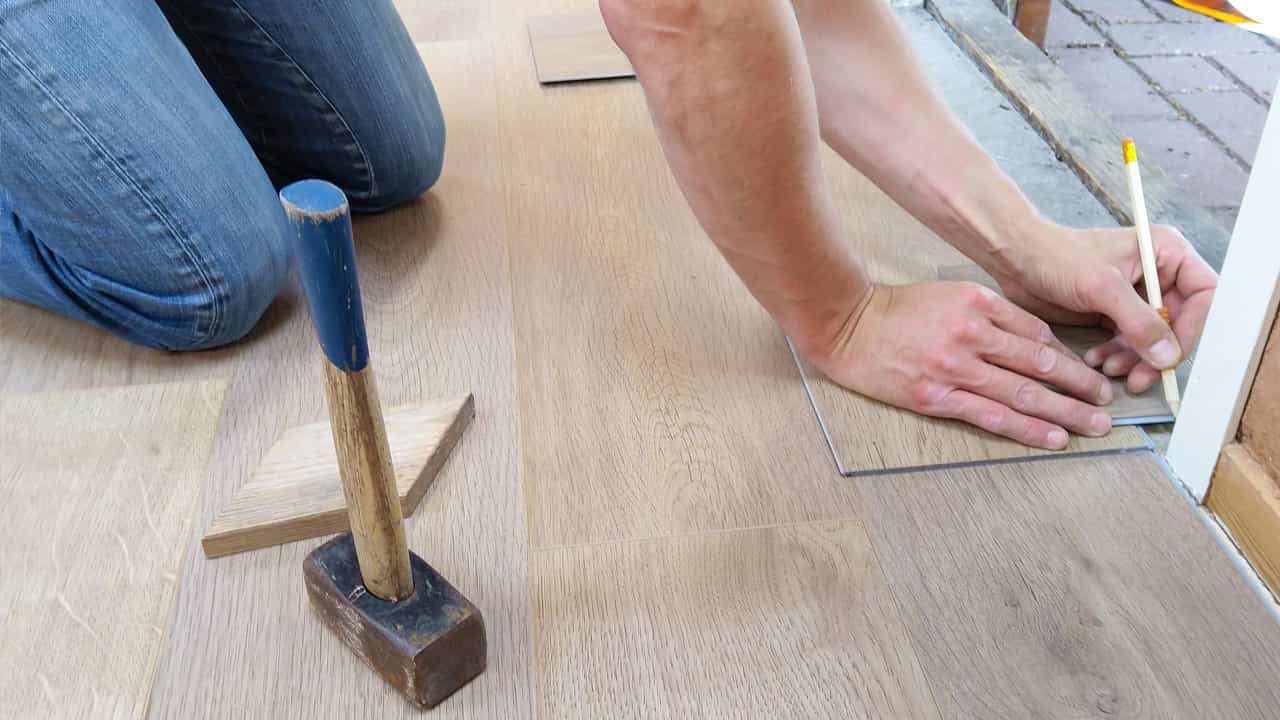 Person installing a wood floor.