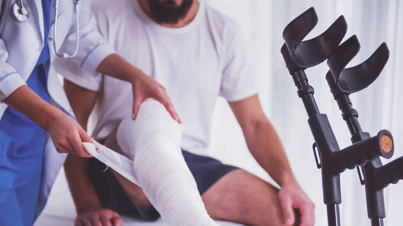 Young man with broken leg