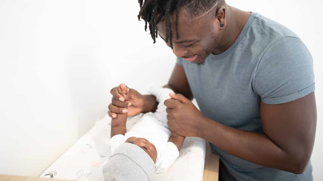 Young father with his newborn baby.