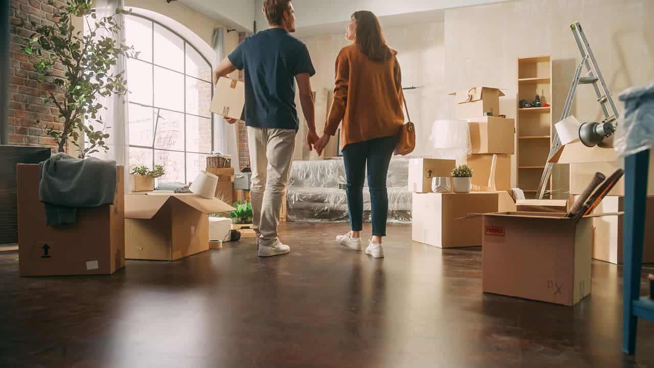 Young couple looking around new home