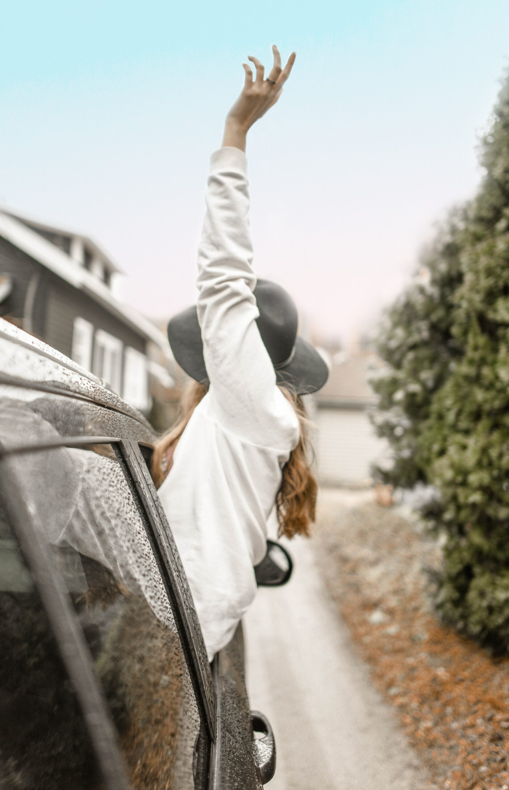 Raising hand out of window of car