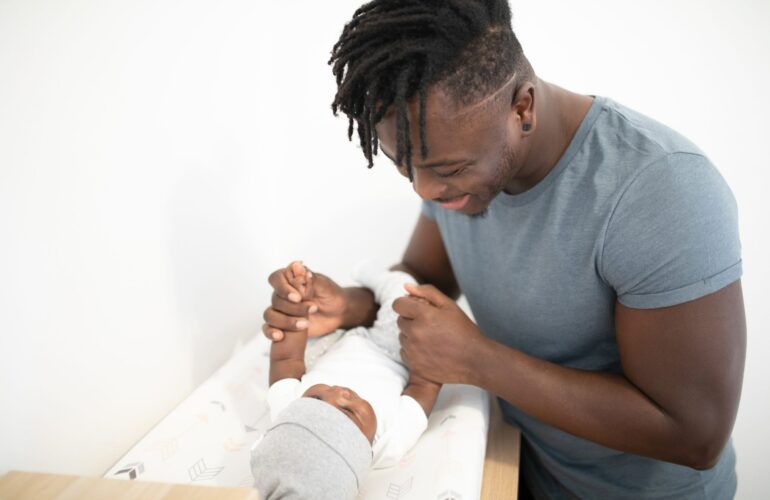 Black And Smiling at His Baby
