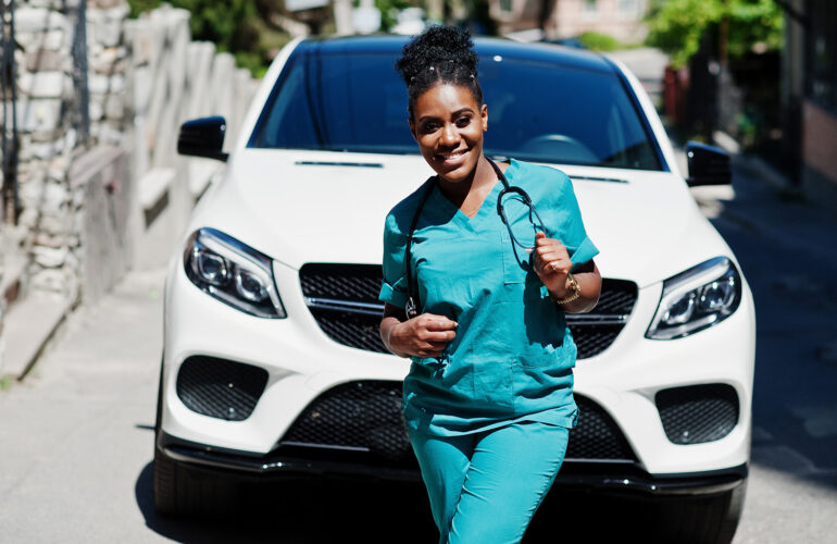 female healthcare in front of car